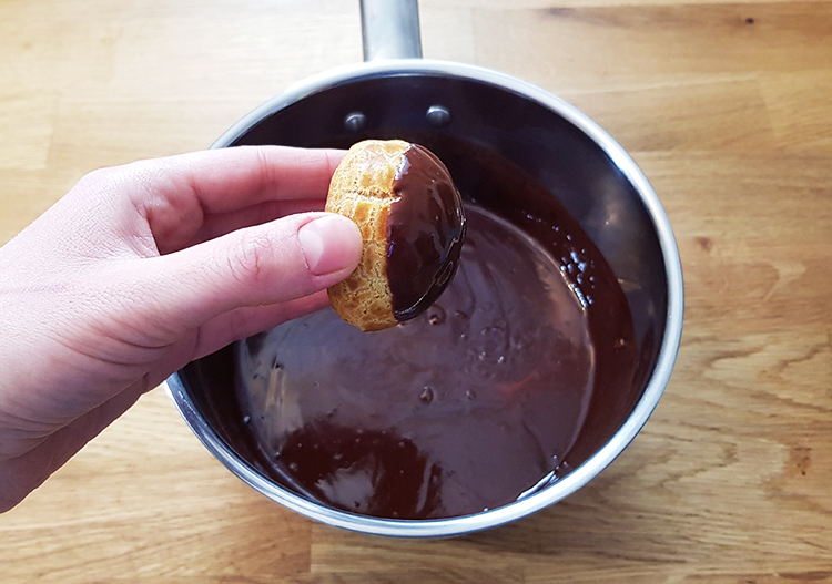 Choux trempés dans la sauce au chocolat